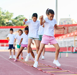 Obraz premium Young children having athletic exercise class running on the track, healthy lifestyle and children sport education concepts