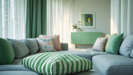 Green striped pillows adorn the cozy grey sofa in the living room setting