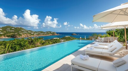 Fototapeta premium High-end resort with infinity pool, white umbrellas, and sun loungers on the terrace facing a peaceful tropical ocean view