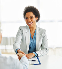 Portrait of a businesswoman or real estate agent or doctor shaking hands and signing a deal contract  with senior couple in his office