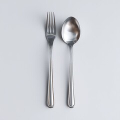 Stainless steel fork and spoon on white background