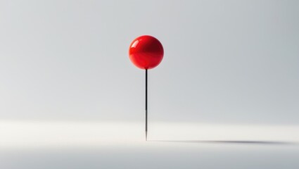 Single sewing push pin with red head on white background