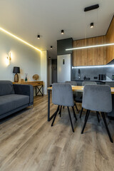 Obraz premium Open-Plan Kitchen and Living Room with Cozy Lighting