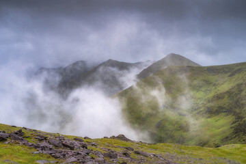 A breathtaking and stunning view of magnificent, misty Carrauntoohil mountain that are covered entirely in vibrant and lush greenery, creating a serene and tranquil atmosphere, Kerry, Ireland