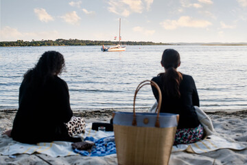 Young women on vacation in Biscaros enjoying the sunset