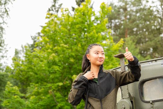 Low angle view of female farmer showing thumbs up gesture