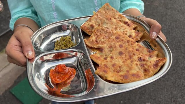 Alu and pyaz paratha served with mango and chilly pickle