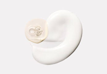 samples of cosmetic care products smear of cream and serum texture on a light background