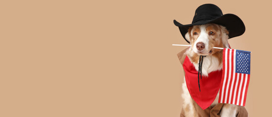 Cute dog in cowboy hat with USA flag on beige background. Independence Day celebration