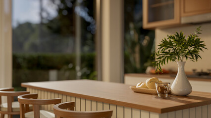 Close up a glass of coffee and breads on plate and with vase on wooden counter with chair in kitchen