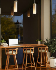 Blank screen laptop and books on a wooden counter with stool chairs under cafe's candle light lamp.