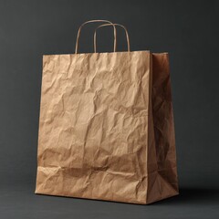 Crinkled kraft paper shopping bag against dark background