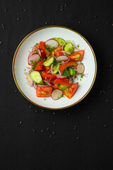 Fresh vegetable salad with radish and cucumbers.