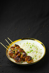 Grilled shrimp skewers with rice.