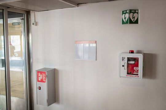 Automated External Defibrillator with fire alarm mounted on wall