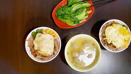 Delicious Hsinchu City cuisine — smoked duck meat on rice, fried egg, pickled cucumbers, blanched vegetables, duck meatball soup,a  temple-front eatery restaurant
