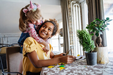 Children art and craft concept. Multiethnic siblings, friends spending time with handicraft at home