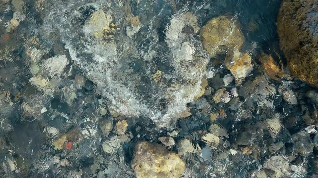 Paceful Movement Of The Creek Water Over The Natural Stones 
