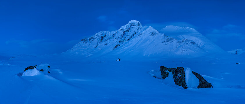 Panoramic view of snow covered mountain during winter at dusk