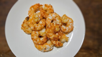 Enjoying eating delicious crispy garlic-fried shrimp and juicy stir-fried shrimp with fresh seafood with chopsticks— traditional Taiwanese stir-fry restaurant cuisine