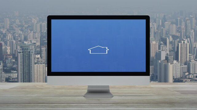 Hammer and wrench with house icon on desktop modern computer monitor screen on wooden table over office building tower and skyscraper in city, Business home service online concept