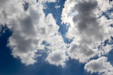 beautiful blue sky with lush white clouds in sunny bright weather