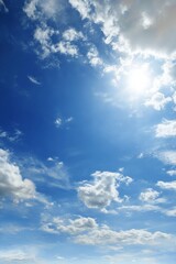 Bright Blue Sky with Puffy White Clouds and Shining Sun