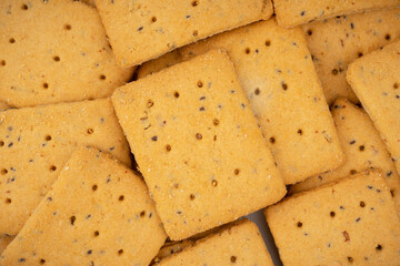 Cereal crackers with flax and sesame seeds isolated on white. Dry salted cracker cookies.Stack of various crispy wheat, rye and corn tortillas with sesame and sunflower seeds on white background