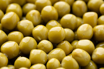 Fresh green peas background, texture of perfect peeled sweet pea grains as background. Vegetable background, vegetable protein, healthy products. Canned peas.