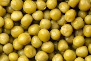 Fresh green peas background, texture of perfect peeled sweet pea grains as background. Vegetable background, vegetable protein, healthy products. Canned peas.