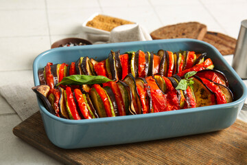 Baking dish of tasty Ratatouille on white tile background