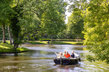 Group of female friends sailing the city canals in a sloop on a beautiful sunny day in Leiden in South-Holland The Netherlands
