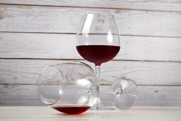 Glasses with red wine on a light background.