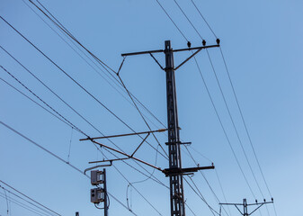 A tall power pole with many wires coming out of it