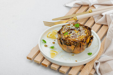 Delicious baked artichoke with parmesan cheese and pistachio. Olive oil, garlic, parsley and lemon