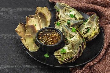 Traditional italian artichoke «alla romana», cooked carciofi vegetable. Olive oil, garlic, parsley