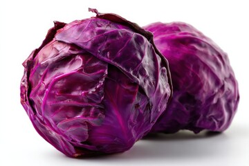 Obraz premium Two Vibrant Red Cabbages Against a White Backdrop, Showcasing Fresh Produce and Healthy Eating Habits for a Nutrition Campaign : Generative AI