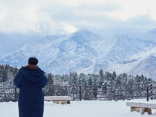 観光名所中山道の馬籠宿の展望台の雪景色と観光客の姿
