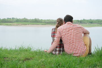 Family on picnic near the lake, looking at view