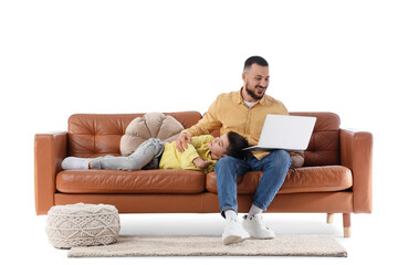 Happy father using laptop while his son sleeping on brown leather sofa against white background