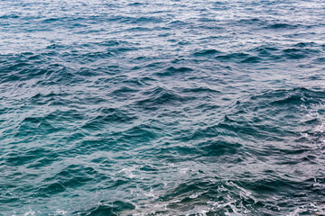 Water surface near the sea shore in overcast rainy weather
