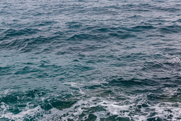 Water surface near the sea shore in overcast rainy weather