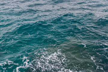 Water surface near the sea shore in overcast rainy weather