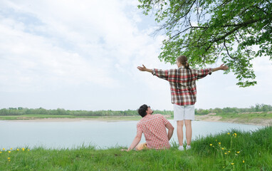 Family on picnic near the lake, looking at view