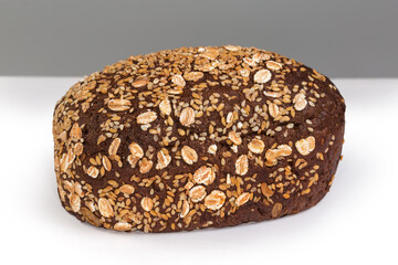Brown bread decorated with sesame and flax seeds and flakes