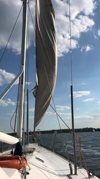 sailing boat on the river. Opening the sail to a tailwind.