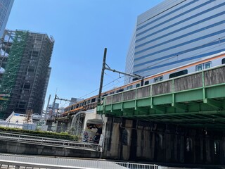 Fototapeta premium Urban Train Passing Over Bridge in Shinjuku Tokyo