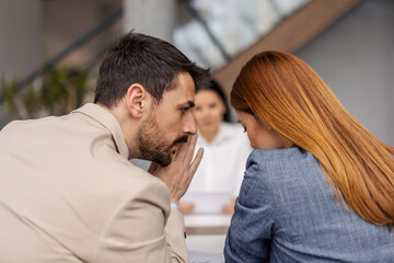 Businesspeople gossiping during the meeting at corporate firm.