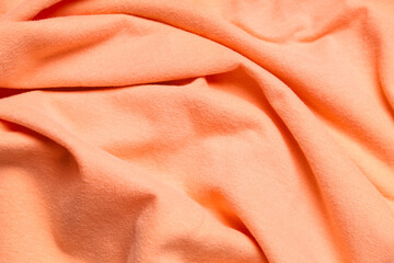 Texture of crumpled coral cloth as background, closeup