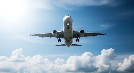 Airplane landing below a sunny sky with clouds